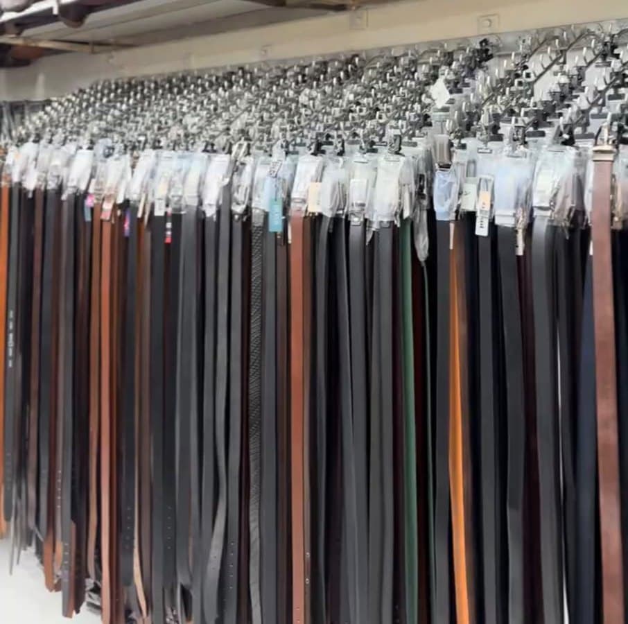 A long rack of leather belts in black, brown and tan