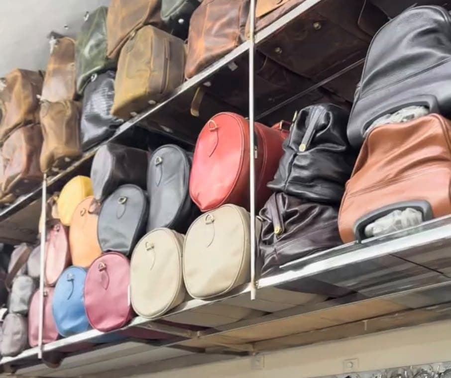 Leather handbags and round sling bags in red, beige, blue and grey