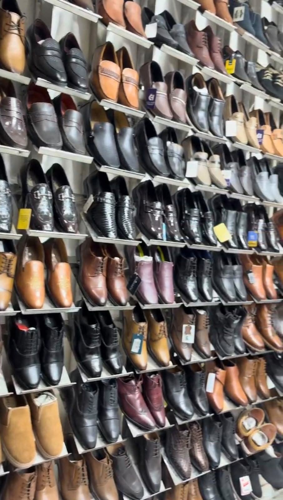 Wall of leather formal shoes, loafers and derbies in black, tan and brown at Chennai Leather Factory