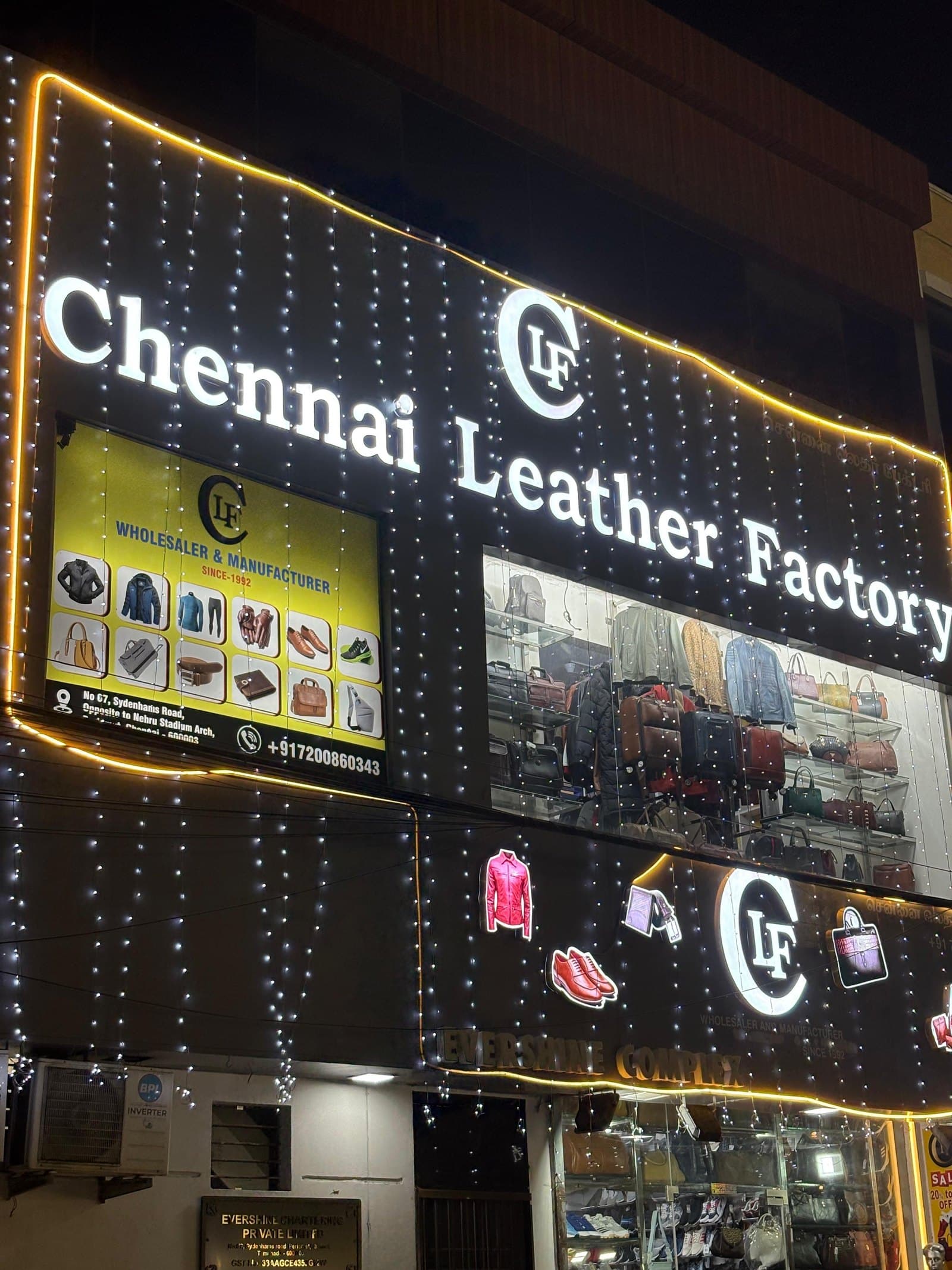 Chennai Leather Factory storefront lit up at night on Raja Muthiah Road, opposite Jawaharlal Nehru Stadium